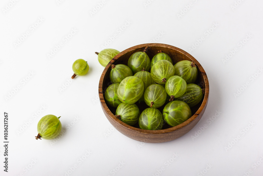 Fresh green gooseberry berries on a white background Fresh green gooseberry berries on a white background