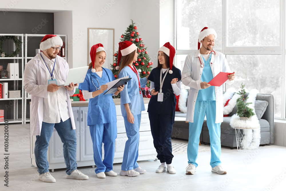 Φωτογραφία Group of doctors in Santa hats at hospital on Christmas eve