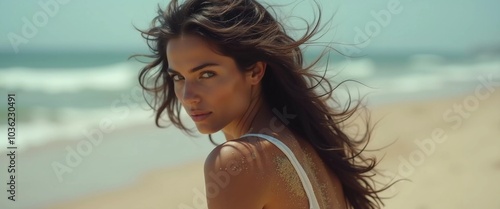 A brunette woman in a swimsuit gazes back while standing near the shoreline. Gentle sea waves lap at her feet under a clear blue sky. Long hair, beautiful young face. Travel and clothing adverts. AI