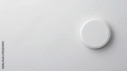 White medicine pill tablet on white background - a symbol of purity and healing. This pristine white pill on an equally white backdrop represents the potential for health and recovery