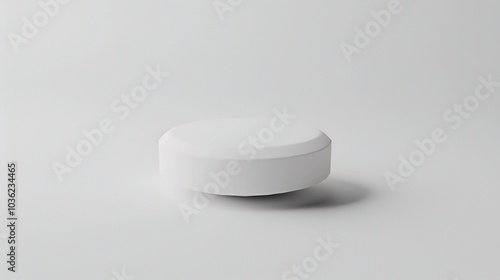 White medicine pill tablet on white background - a symbol of purity and healing. This pristine white pill on an equally white backdrop represents the potential for health and recovery