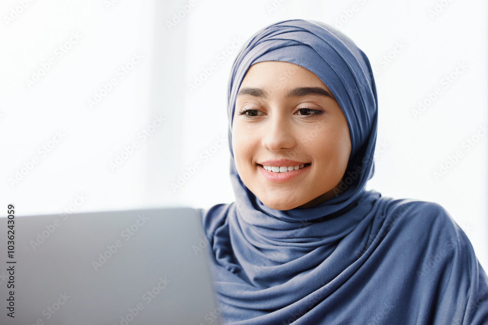 Searching Work Online Concept. Young Muslim Girl Job Seeker In Hijab Looking At Laptop Screen, Checking Vacancies Searching Work Online Concept. Young Muslim Girl Job Seeker In Hijab Looking At Laptop Screen, Checking Vacancies