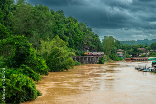 trains running on death railways track crossing kwai river in kanchanaburi thailand these railways important destinations of World War II history built by soldier prisoners photo