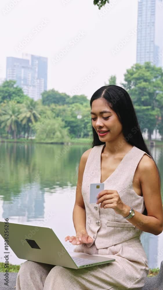 Young businesswoman using laptop for online shopping in slow motion - Bangkok Thailand Young businesswoman using laptop for online shopping in slow motion - Bangkok Thailand