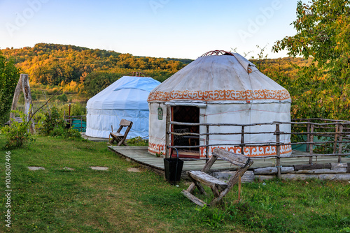 Two tents are sitting in a grassy field, kyrgyz authentic nomadic yurt