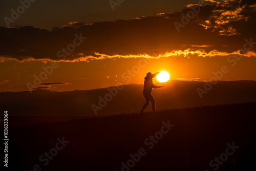 silhouette of a person standing on a mountain top