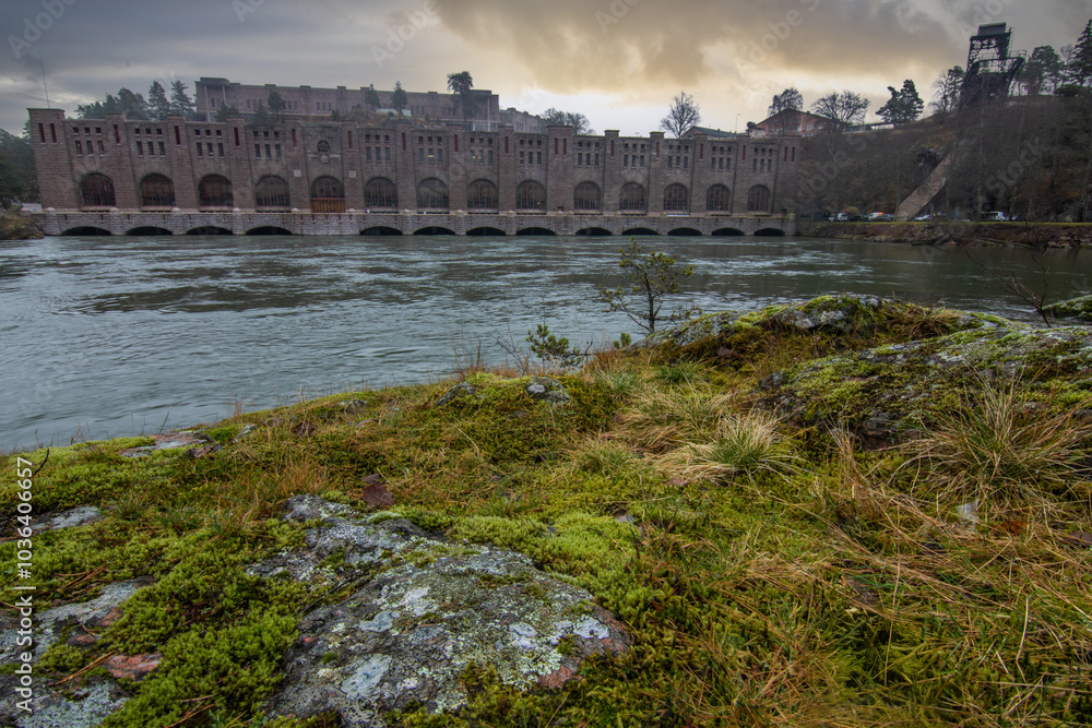 Historical sight, the red brick hydroelectric power station. Rainy weather at sunset by the river in Trollhättan, Sweden, Scandinavia Historical sight, the red brick hydroelectric power station. Rainy weather at sunset by the river in Trollhättan, Sweden, Scandinavia