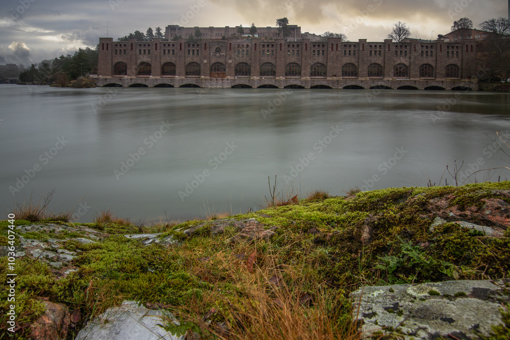 Historical sight, the red brick hydroelectric power station. Rainy weather at sunset by the river in Trollhättan, Sweden, Scandinavia Historical sight, the red brick hydroelectric power station. Rainy weather at sunset by the river in Trollhättan, Sweden, Scandinavia