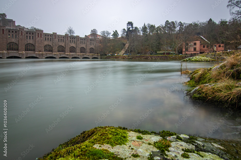 Historical sight, the red brick hydroelectric power station. Rainy weather at sunset by the river in Trollhättan, Sweden, Scandinavia Historical sight, the red brick hydroelectric power station. Rainy weather at sunset by the river in Trollhättan, Sweden, Scandinavia