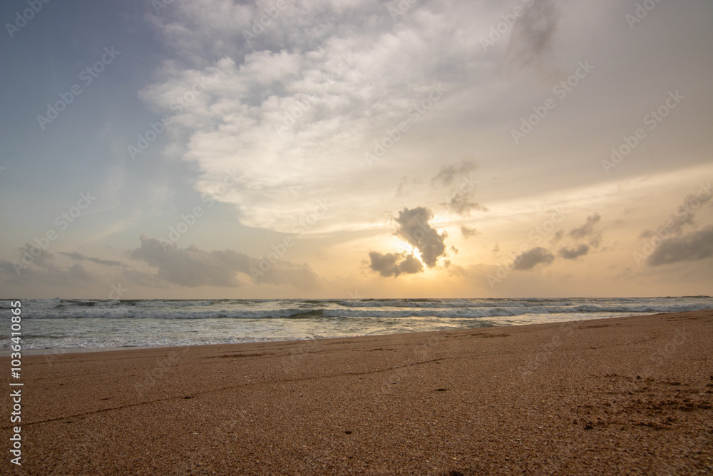 Landscape by the sea. Long deserted beach with water views to the horizon. The waves of a storm break on the sand and give the picture a special touch at sunset. ´ Bentota, Sri Lanka, Asia Landscape by the sea. Long deserted beach with water views to the horizon. The waves of a storm break on the sand and give the picture a special touch at sunset. ´ Bentota, Sri Lanka, Asia
