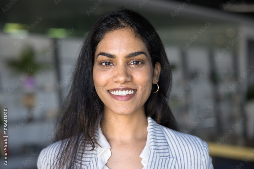 Fototapeta premium Happy beautiful Indian manager girl head shot video conference screen portrait. Positive young woman keeping in white casual office jacket looking at camera with toothy smile, laughing