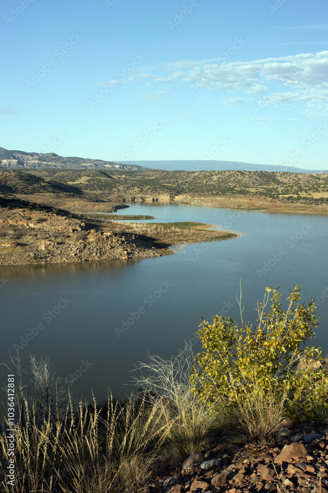 Naklejka premium View of Abiquiu Lake, an Army Corps of Engineers reservoir in northern New Mexico, with pinyon and juniper trees at dawn