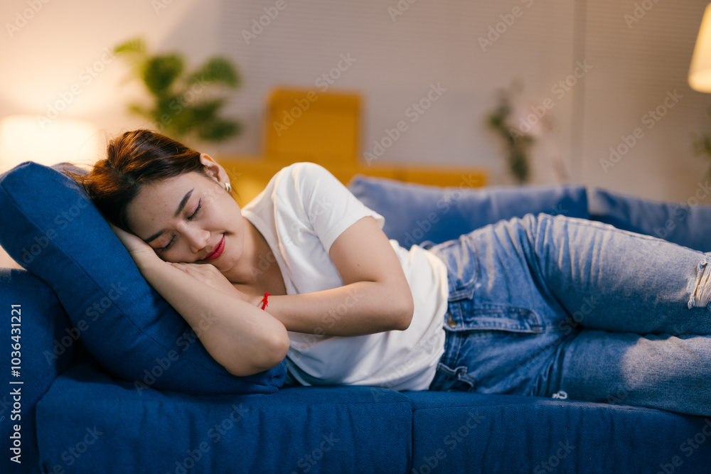 Young woman peacefully sleeps on her couch at home, enjoying relaxation and tranquility. Embracing peace and comfort, she naps in her cozy living room, feeling happy and content Young woman peacefully sleeps on her couch at home, enjoying relaxation and tranquility. Embracing peace and comfort, she naps in her cozy living room, feeling happy and content
