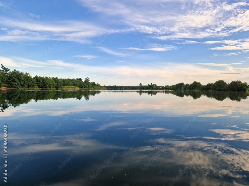 Fototapeta premium Scenic view of Scharmutzelsee with lush greenery along the shore