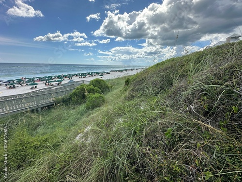 Scenic view of a beach with green umbrellas and people enjoying the sun. Rosemary Beach, Florida photo