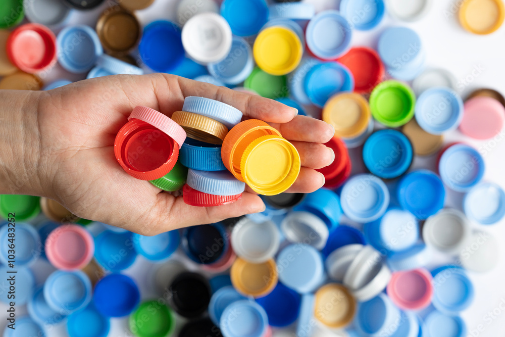 woman hand holding plastic bottles caps for recycling to conserve the environment, Recycling, reuse, garbage disposal, save the world concept. woman hand holding plastic bottles caps for recycling to conserve the environment, Recycling, reuse, garbage disposal, save the world concept.