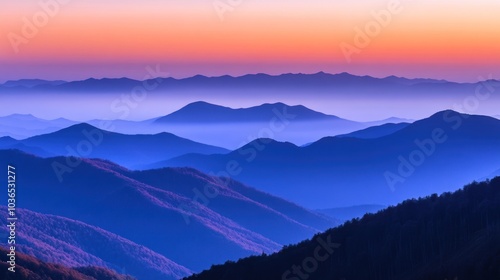 Serene mountain landscape at sunset with layered hills and a colorful sky.