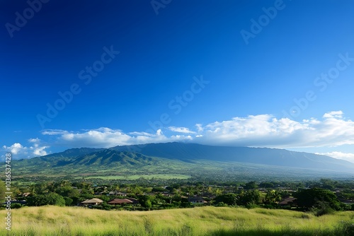 Lush Green Mountain Range with Residential Homes and a Blue Sky