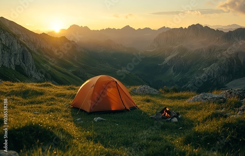 A Glowing Orange Tent Set Up on the Grassy Slopes of a Mountain