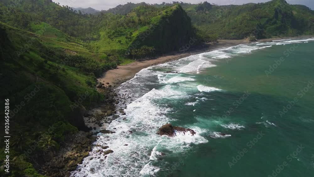 Drone view seaside view with coral reefs, waves, hills and camping spots bordering the Indian Ocean Drone view seaside view with coral reefs, waves, hills and camping spots bordering the Indian Ocean