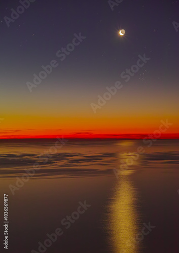 Landscape, sunset and moon with beach and ocean for environment, island destination and tropical. Summer vacation, water and nature with sea horizon for mediterranean coastline, holiday or paradise