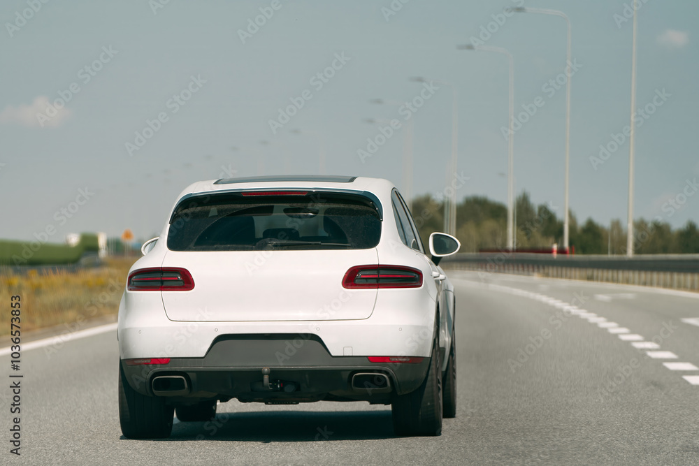 White vehicle on a bright sunny highway. White vehicle on a bright sunny highway.