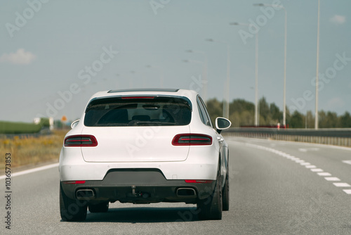 White vehicle on a bright sunny highway.