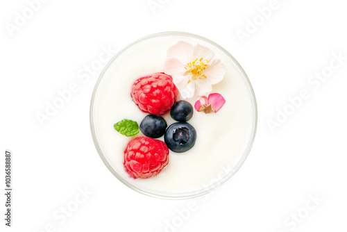 Bowl of creamy yogurt with fresh raspberries, strawberries, blueberries, and mint leaves isolated on white background. Concept of healthy breakfast or snack