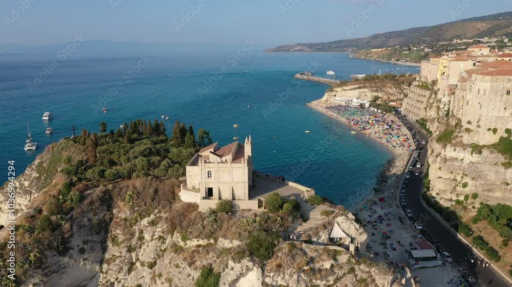 Aerial view of cliffs, historic tourist center of the city, monastery Santuario di Santa Maria dell'Isola di Tropea sunny summer day in Calabria region, Italy Aerial view of cliffs, historic tourist center of the city, monastery Santuario di Santa Maria dell'Isola di Tropea sunny summer day in Calabria region, Italy