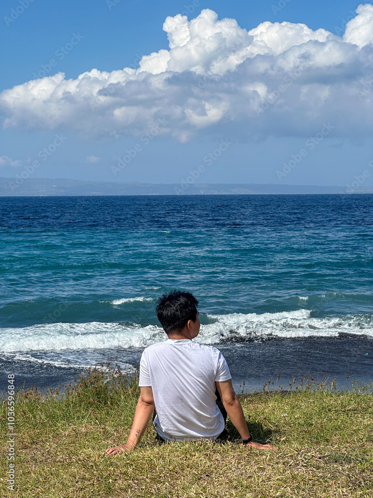 indonesian man enjoying beach on Bali indonesian man enjoying beach on Bali
