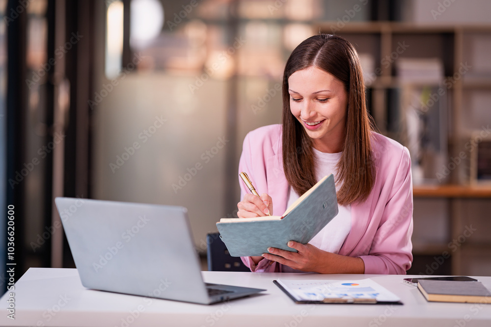 Beautiful professional woman sitting at table smiling while reading important documents with financial graphs and accounting of company. Beautiful professional woman sitting at table smiling while reading important documents with financial graphs and accounting of company.