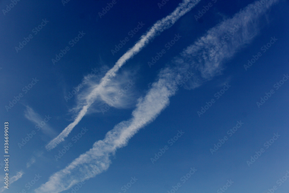 Landscape of plane tracks on a blue sky on a sunny day Landscape of plane tracks on a blue sky on a sunny day