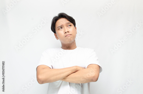 Thoughtful asian man thinking and wondering with hand touching skin as thinking gesture. Thoughtful confused asian man thinking and wondering to choose something. man feeling uncertain and unsure.	