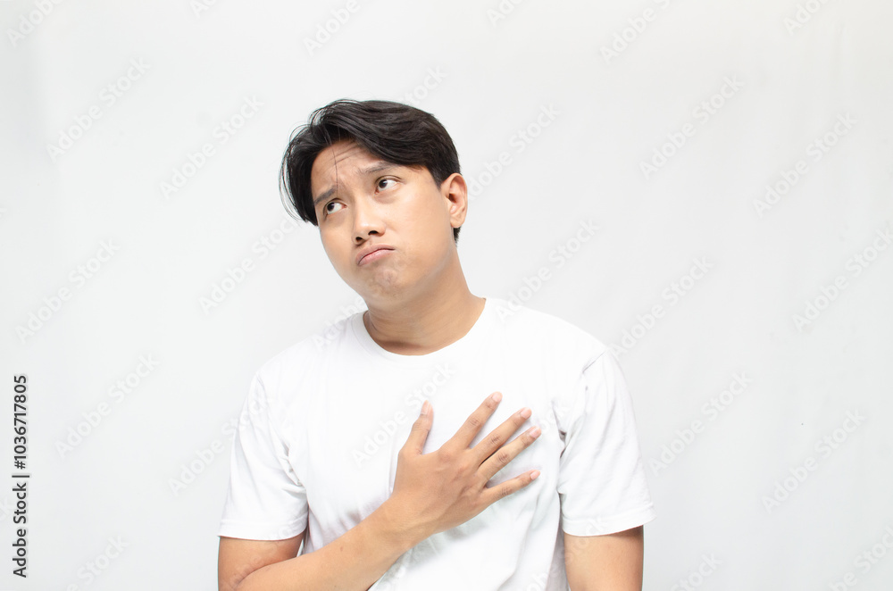 Thoughtful asian man thinking and wondering with hand touching skin as thinking gesture. Thoughtful confused asian man thinking and wondering to choose something. man feeling uncertain and unsure. Thoughtful asian man thinking and wondering with hand touching skin as thinking gesture. Thoughtful confused asian man thinking and wondering to choose something. man feeling uncertain and unsure.