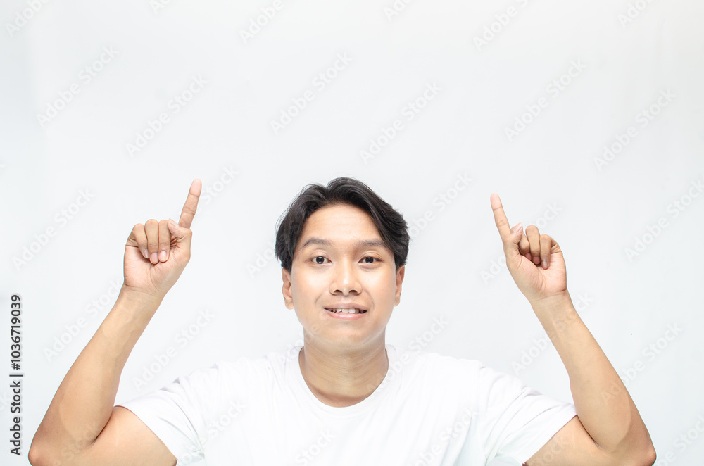 Atrractive young asian man in white t-shirt pointing his finger to advertise something. handsome asian man promoting something and pointing his finger to copy space showing discount or promotion. Atrractive young asian man in white t-shirt pointing his finger to advertise something. handsome asian man promoting something and pointing his finger to copy space showing discount or promotion.