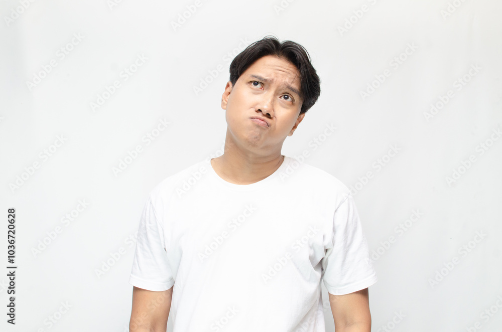 Thoughtful asian man thinking and wondering with hand touching skin as thinking gesture. Thoughtful confused asian man thinking and wondering to choose something. man feeling uncertain and unsure. Thoughtful asian man thinking and wondering with hand touching skin as thinking gesture. Thoughtful confused asian man thinking and wondering to choose something. man feeling uncertain and unsure.