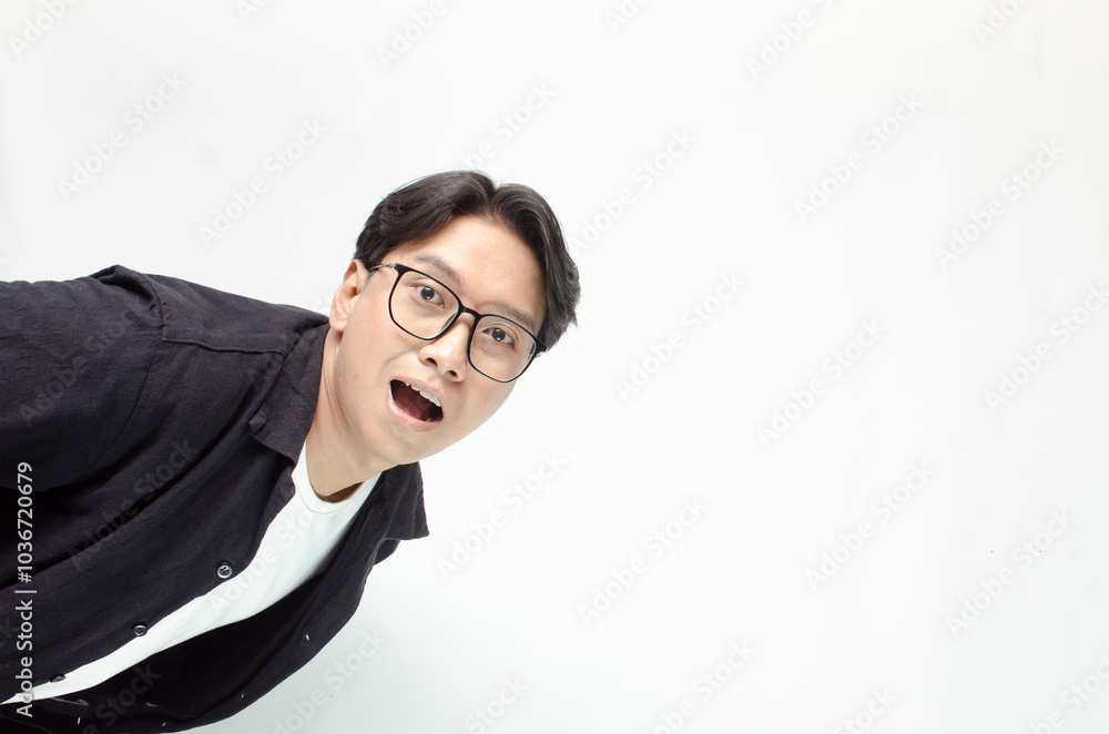 attractive young Asian man hand on mouth telling secrets and whispering gossip. A young Asian student announcing promotion with a wow expression. attractive young Asian man hand on mouth telling secrets and whispering gossip. A young Asian student announcing promotion with a wow expression.