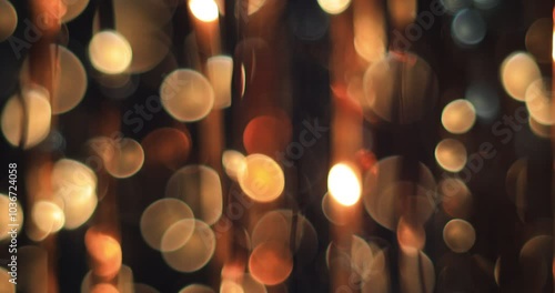 Warm, festive lights shimmer through hanging golden streamers, enhancing the celebratory ambiance as evening descends