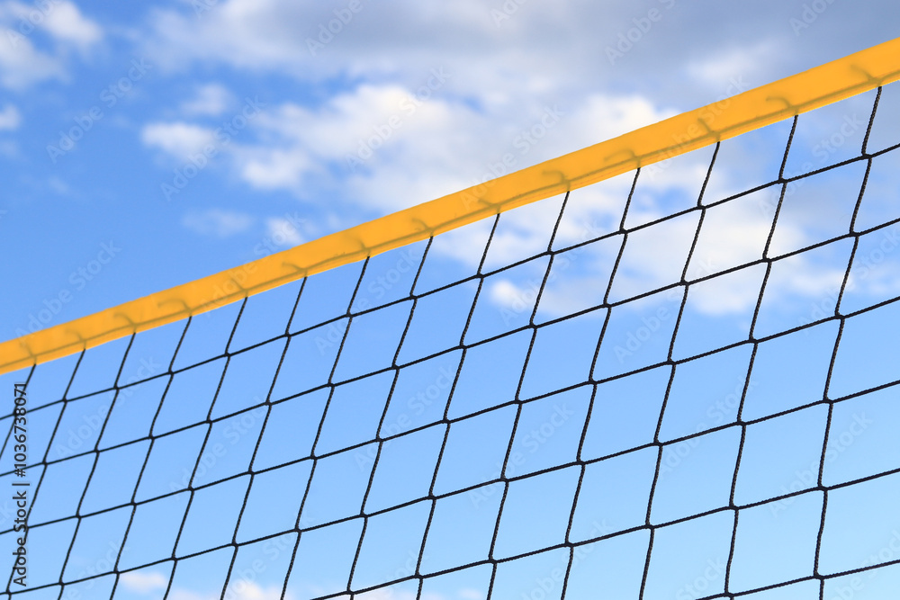 Beach volleyball net close-up. Fragment of a volleyball net on the beach against the blue sky. Sport, beach volleyball. Active recreation concept. Background. Detail of the yellow net. Sports ground Beach volleyball net close-up. Fragment of a volleyball net on the beach against the blue sky. Sport, beach volleyball. Active recreation concept. Background. Detail of the yellow net. Sports ground