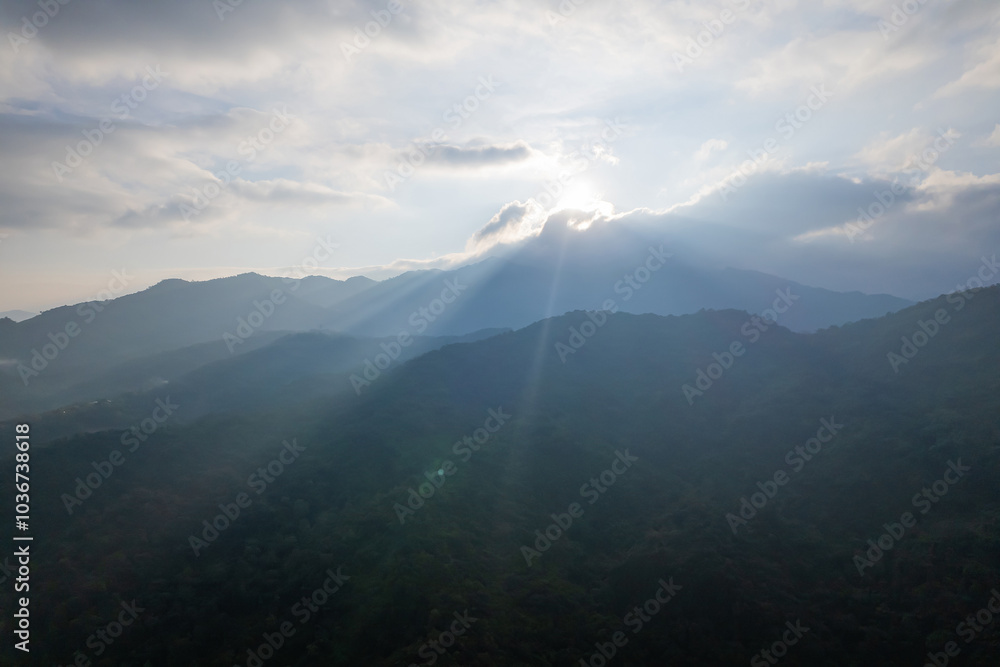 Naklejka premium Aerial view of amazing mountain landscape colorful sunset over the cloudy sky.
