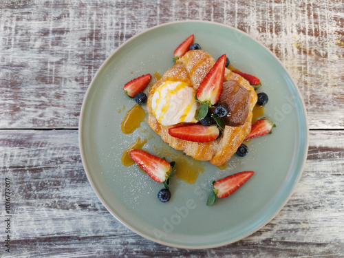 chocolate and vanilla ice cream on croissant with fresh strawberry photo