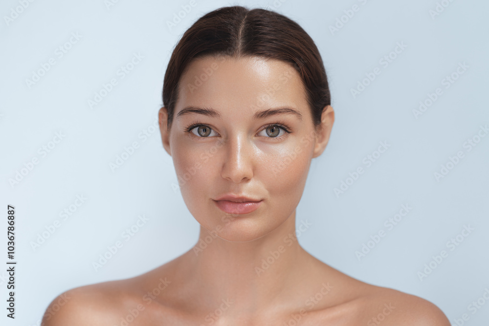 Portrait of a young woman with glowing, natural skin looking directly at the camera. The soft lighting and minimalistic background emphasize her flawless complexion, perfect for beauty and skincare Portrait of a young woman with glowing, natural skin looking directly at the camera. The soft lighting and minimalistic background emphasize her flawless complexion, perfect for beauty and skincare