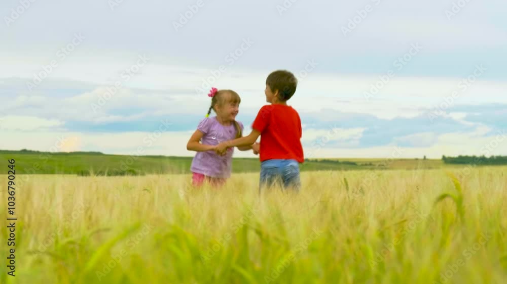 Sibling Little Kids Having Fun in the Summer Meadow. Boy and Girl Holding Hands and Spinning in a Field. Carefree Childhood Concept. Summertime Sibling Little Kids Having Fun in the Summer Meadow. Boy and Girl Holding Hands and Spinning in a Field. Carefree Childhood Concept. Summertime