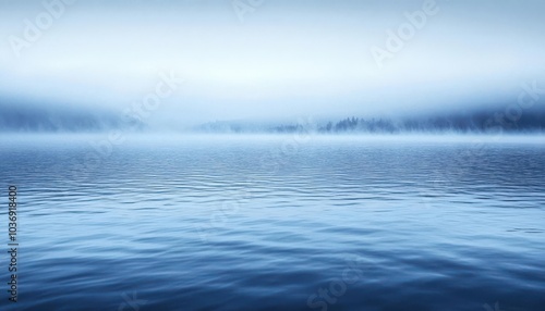 A serene landscape featuring calm waters and foggy hills, evoking tranquility and reflection.