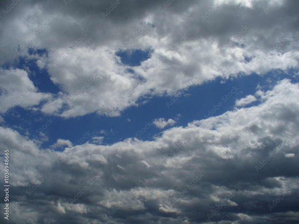 Eyes and face smiling in sky with clouds - natural arrangement of clouds in blue sky. Topics: weather, meteorology, atmosphere, air space, season, optimism, cheerfulness Eyes and face smiling in sky with clouds - natural arrangement of clouds in blue sky. Topics: weather, meteorology, atmosphere, air space, season, optimism, cheerfulness