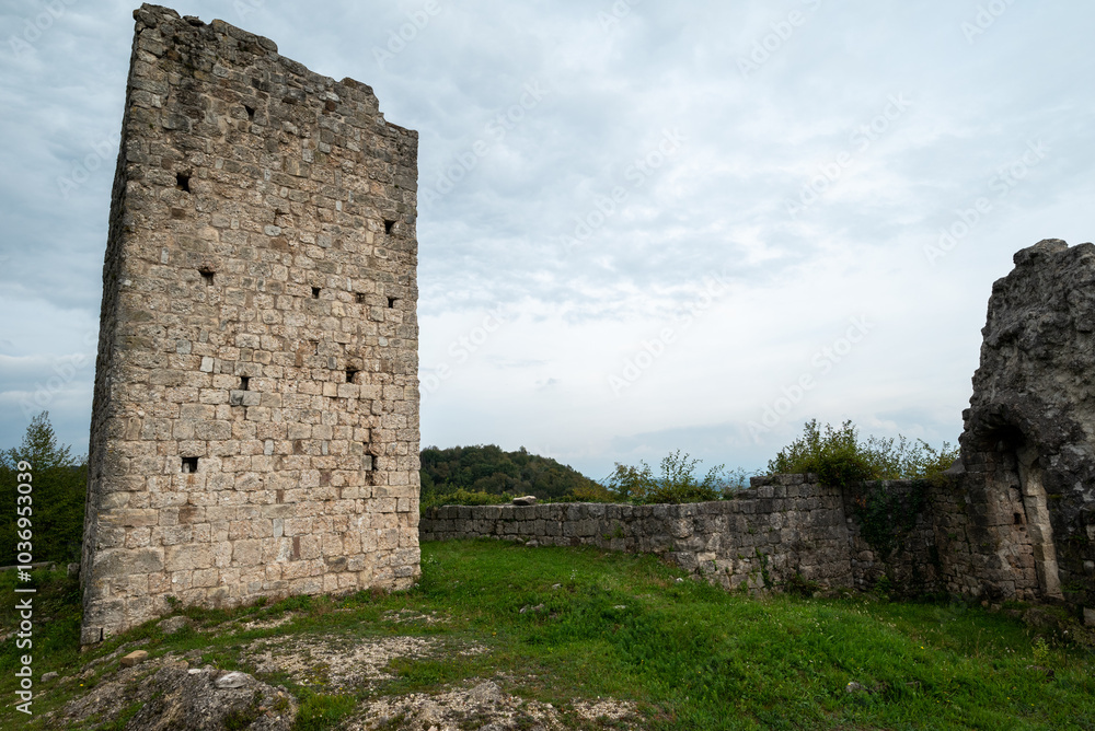 The tower of the medieval castle of Solimbergo, fraction of Sequals in Friuli. These ruins are at the top of a hill, we are in autumn The tower of the medieval castle of Solimbergo, fraction of Sequals in Friuli. These ruins are at the top of a hill, we are in autumn