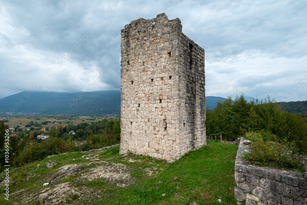 The tower of the medieval castle of Solimbergo. These ruins are at the top of a hill with a wonderful view of the city of Sequals. We see a wooden staircase with its ledge. The tower of the medieval castle of Solimbergo. These ruins are at the top of a hill with a wonderful view of the city of Sequals. We see a wooden staircase with its ledge.