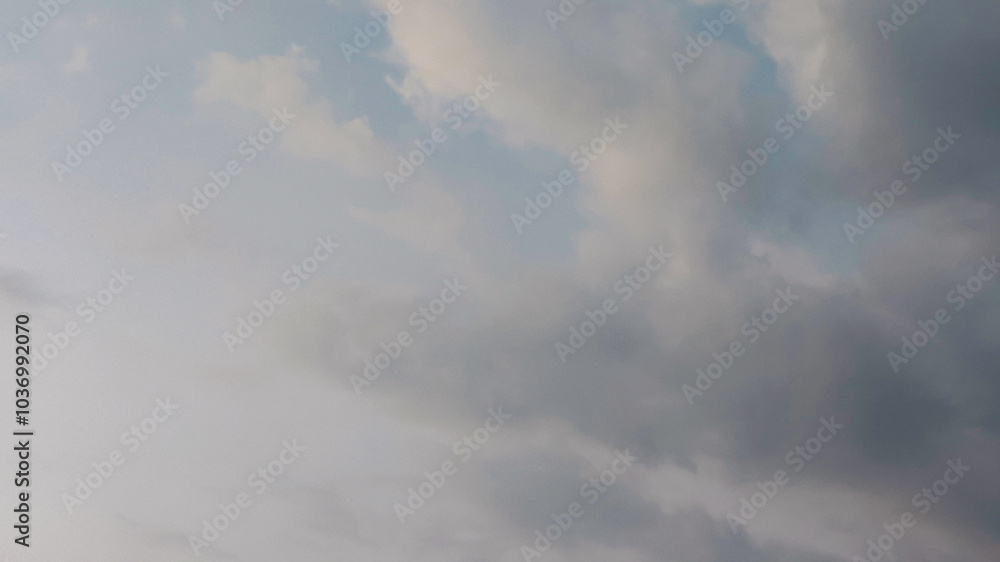 Obraz premium The sky has the light of the sun, the sky is blue, there are small and large clouds alternating and moving slowly, with the sunlight passing, creating a miraculous abstract shape, summer day.
