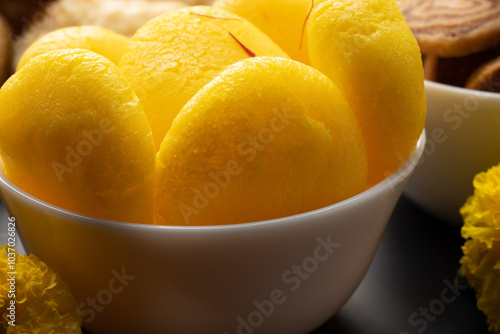 Rajbhog or kesar bati is a traditional Bengali sweet Rasgulla made using paneer or chena and flavoured with saffron and rose essence photo