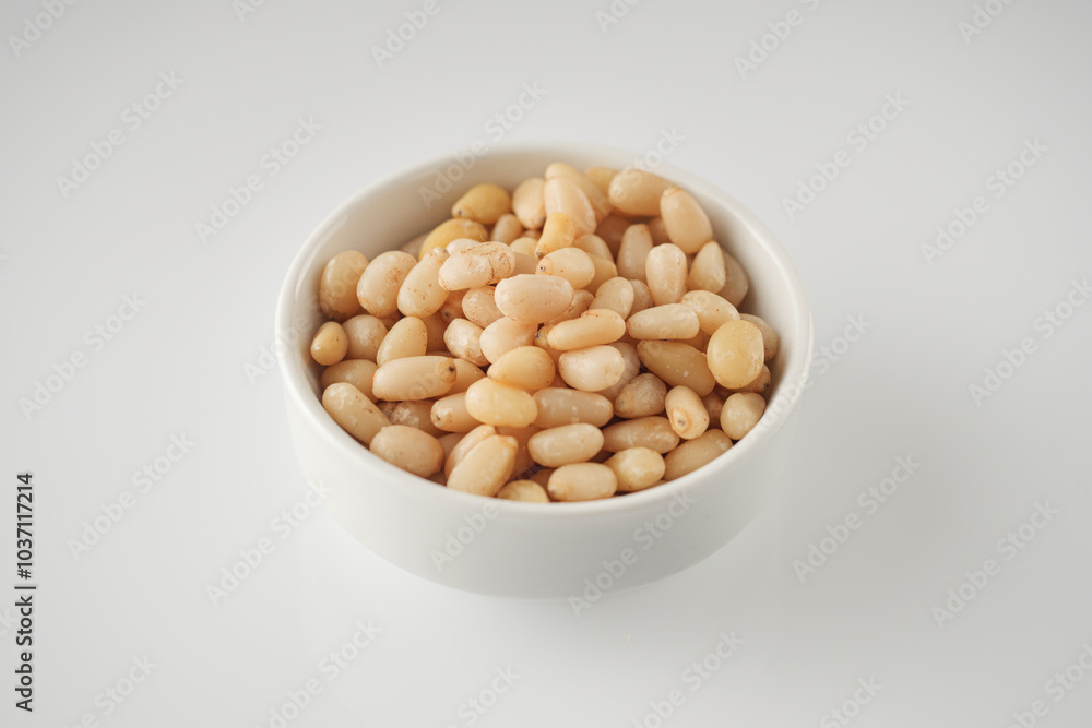 Shelled Pine Nuts: Close-Up of Roasted Siberian Seeds on a White Background Shelled Pine Nuts: Close-Up of Roasted Siberian Seeds on a White Background